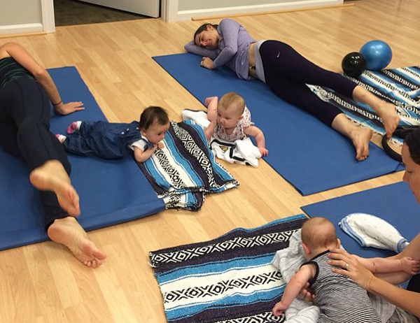 Mommies and babies practicing pilates